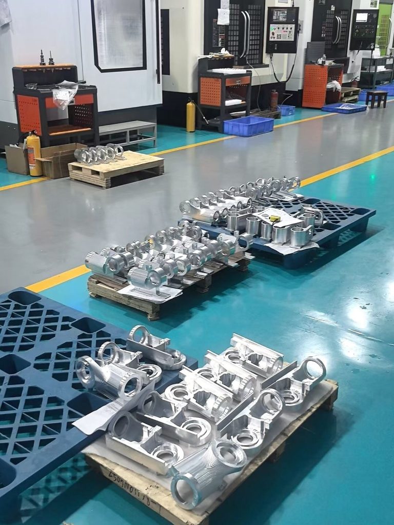 Supplier production inspection pallets with aluminum CNC machined parts staged for quality review