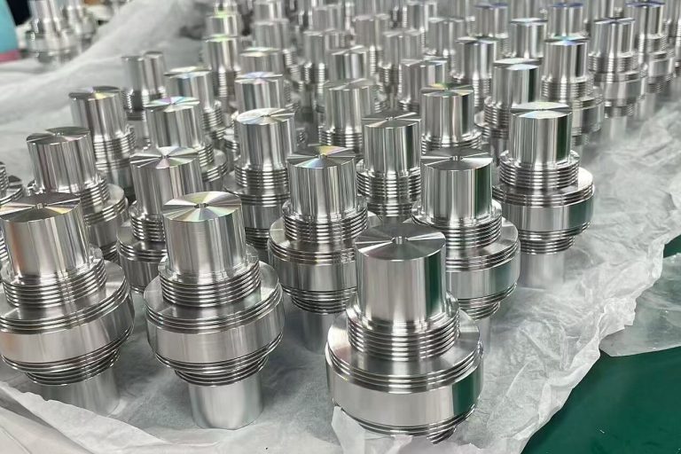 Batch of stainless steel CNC turned threaded components showing consistent surface finish and repeatability