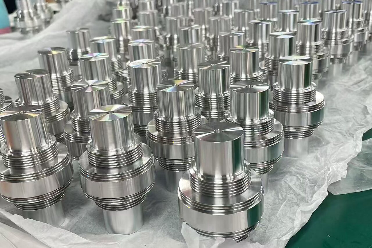 Batch of stainless steel CNC turned threaded components showing consistent surface finish and repeatability